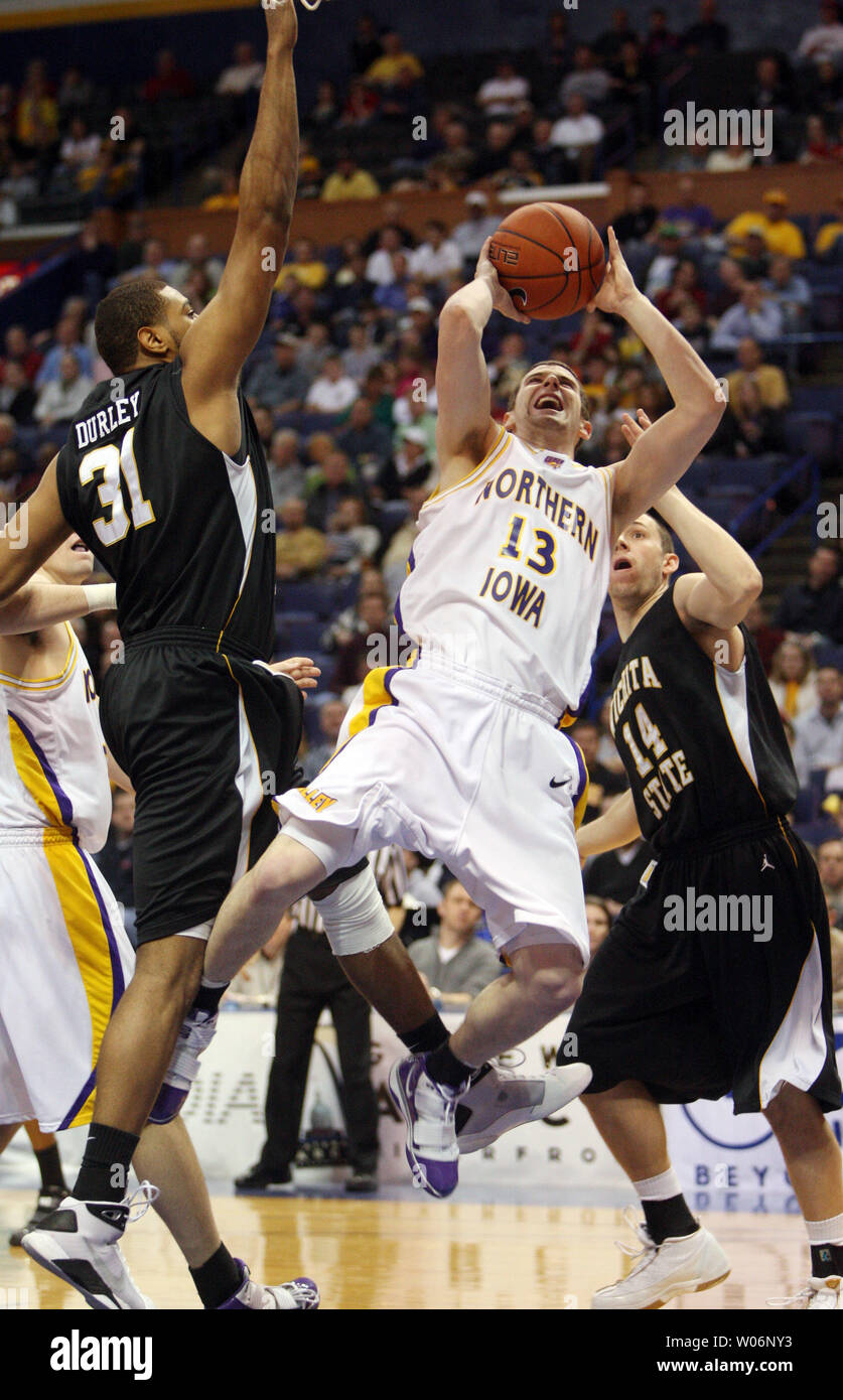 University of Northern Iowa Panthers Johnny Moran (13) throws up the basketball  in front of Wichita State Shockers JT Durley (L) and Graham Hatch during the first half of the Missouri Valley Conference Tournament Championship game at the Scottrade Center in St. Louis on March 7, 2010. Northern Iowa won the championship 67-52.   UPI/Bill Greenblatt Stock Photo