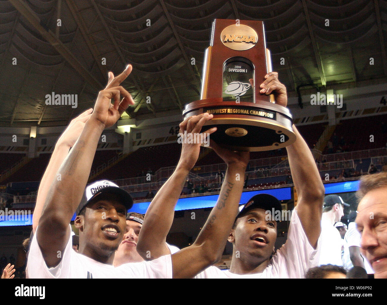 Members of the Michigan State basketball team hoist the winners trophy in  the NCAA Midwest Regional Championship game at the Edward Jones Dome in St.  Louis on March 28, 2010. Michigan State
