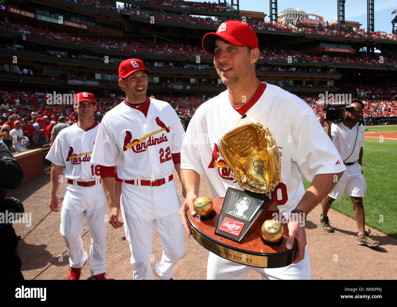 St. Louis Cardinals pitcher Adam Wainwright leaves the field with his Golden Glove presented to him before a game against the New York Mets at Busch Stadium in St. Louis on April 17, 2010.  Walking with Wainwright are teammates Joe Mather (22) and Bryan Anderson.  UPI/Bill Greenblatt Stock Photo