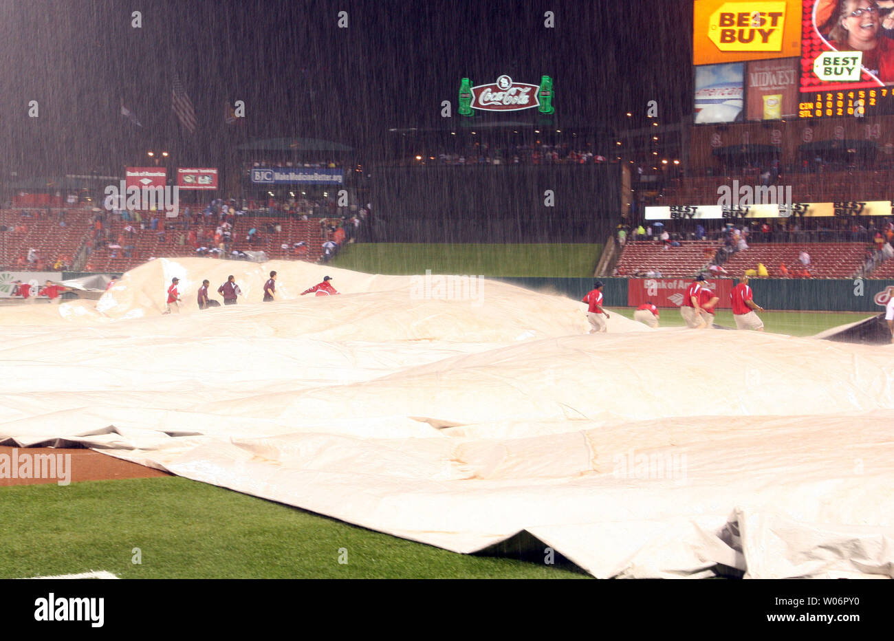 Busch Stadium field crew fight to keep the tarp down as heavy winds and rain suspend the Cincinnati Reds - St. Louis Cardinals baseball game in the sixth inning in St. Louis on April 30, 2010.   UPI/Bill Greenblatt Stock Photo
