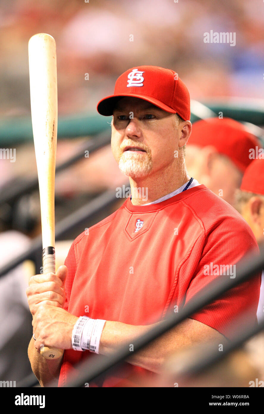 St. Louis Cardinals hitting coach Mark McGwire holds a bat in the