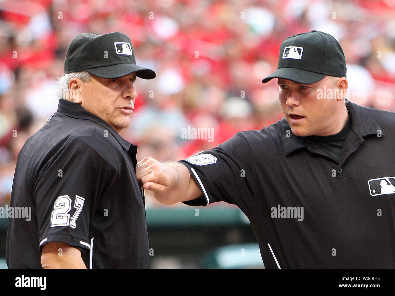 Third base umpire Mark Carlson (R) gives home plate umpire Larry