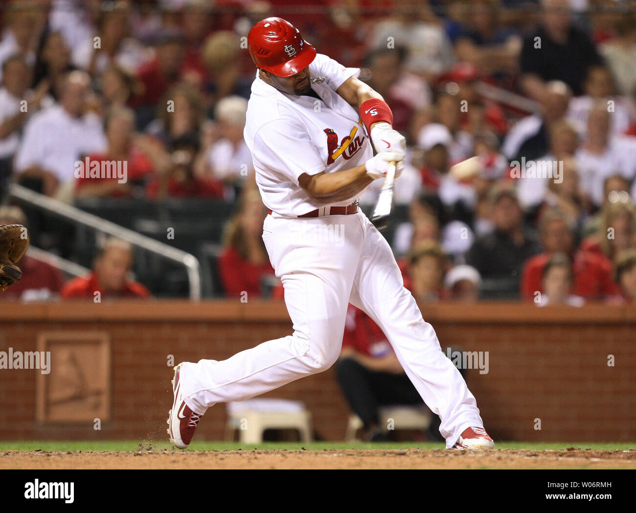 St. Louis Cardinals Albert Pujols swings as he hits a solo home run in the  seventh inning against the Milwaukee Brewers at Busch Stadium in St. Louis  on July 1, 2010. UPI/Bill