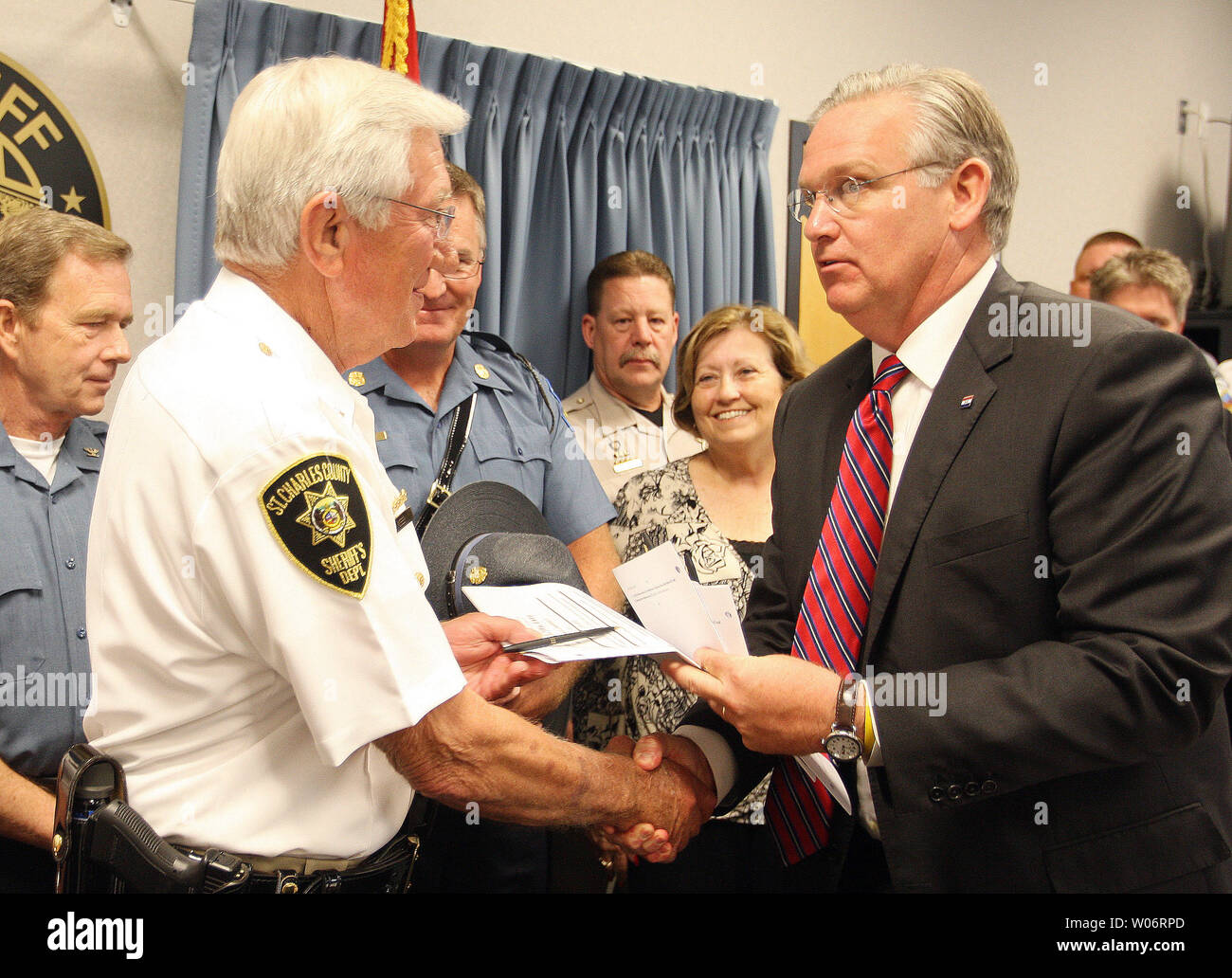 Missouri Governor Jay Nixon (R) presents St. Charles County Sheriff Tom Neer with the first copy of  a bill just signed that makes K2, a new drug in the area, a controlled substance in O'Fallon, Missouri on July 6, 2010. K2, a synthetic substance similar to marijuana, has become popular in recent months.The law bans synthetic compounds that are sprayed on dried herbs and flowers and often sold as incense.The product produces a marijuana-like high when smoked or inhaled. It is sold in smoke shops and gas stations around the state. UPI/Bill Greenblatt Stock Photo