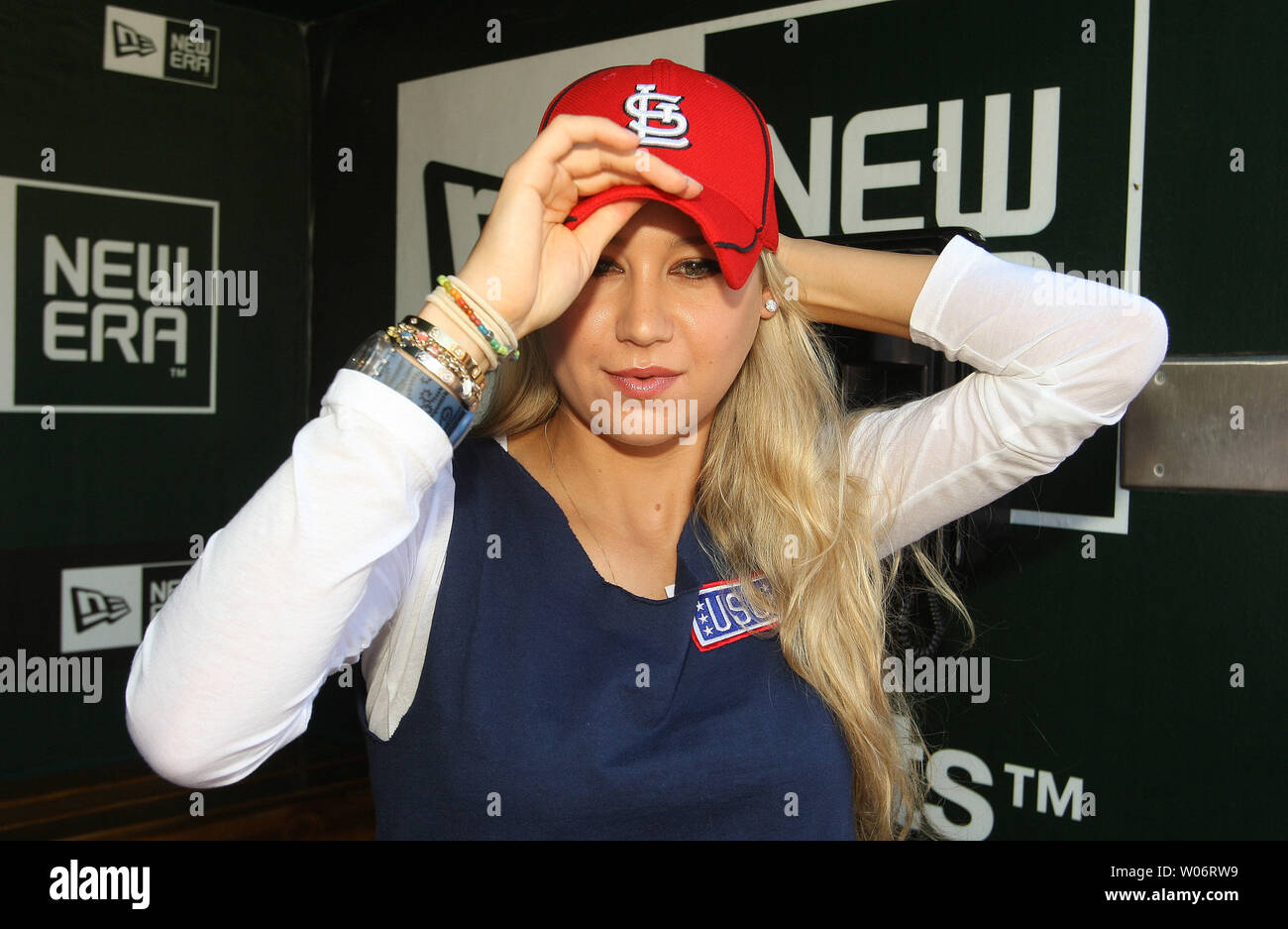 World Team Tennis player Anna Kournikova tries on a Cardinals hat in the dugout before the Los Angeles Dodgers - St. Louis Cardinals baseball game at Busch Stadium in St. Louis on July 17, 2010. UPI/Bill Greenblatt Stock Photo