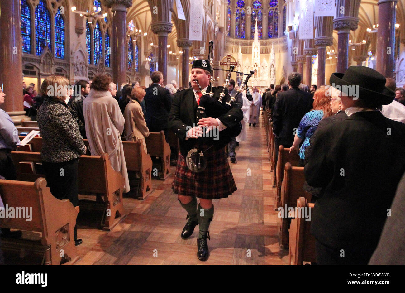 A bagpiper leads the casket of Max Starkloff, an activist for disability rights, out of the  Saint Francis Xavier College Church during his funeral in St. Louis on January 4, 2011. Starkloff, who died on December 27, 2010 at the age of 73, co-founded Paraquad, a pioneering Center for Independent Living, and in 2003 co-founded the Starkloff Disability Institute. His advocacy secured legislation for first-in-the nation public improvements like curb cuts, disabled parking, city bus lifts and the passage of the landmark Americans with Disabilities Act in 1990. Starkloff was the co-founder of the N Stock Photo