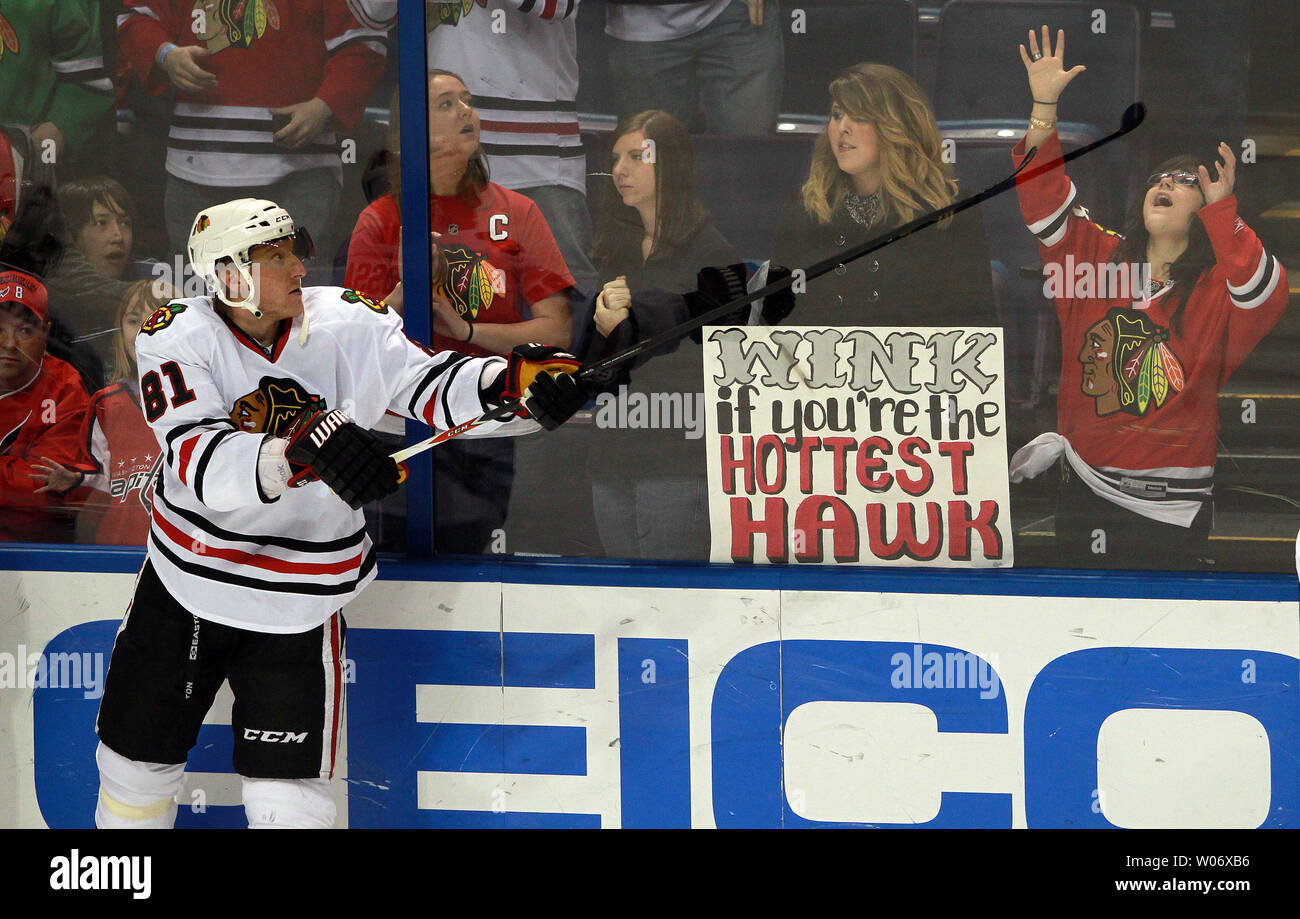 Chicago Blackhawks Marian Hossa flips a puck to a young fan during warmups before a game against the St. Louis Blues at the Scottrade Center in St. Louis on February 21, 2011.  UPI/Bill Greenblatt Stock Photo