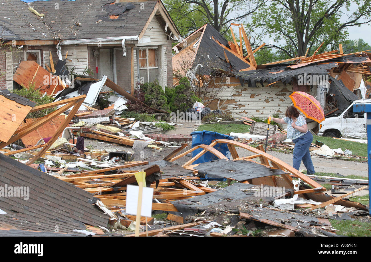A woman looks for possessions three days after a tornado devastated the