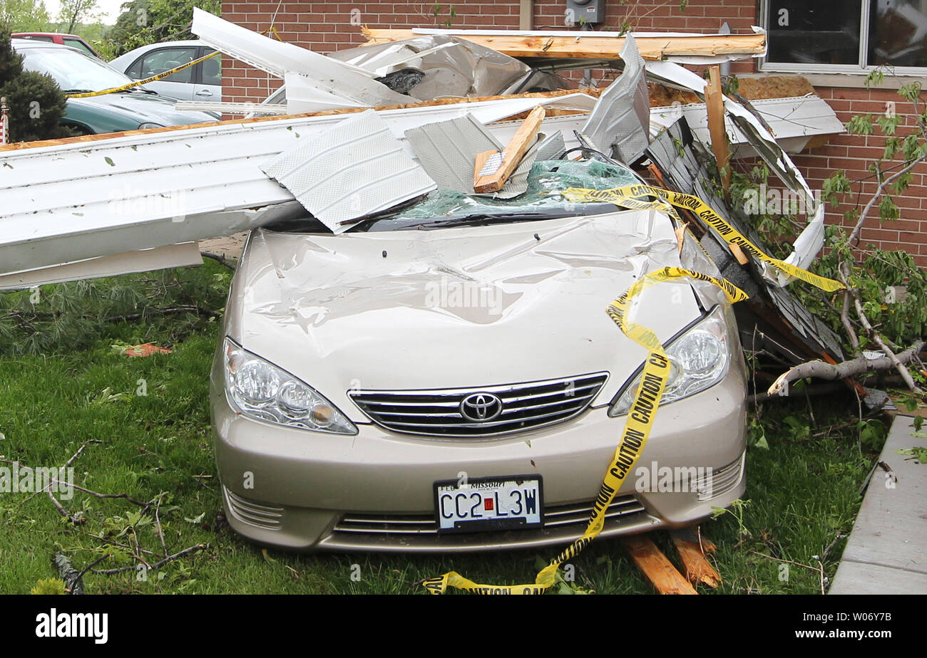 A portion of a garage sits in a car, three days after a tornado
