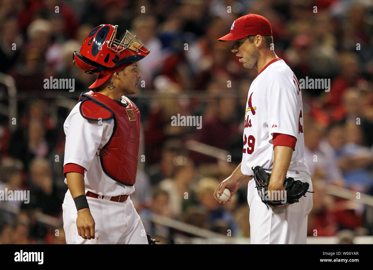 St. Louis Cardinals pitcher Chris Carpenter (R) talks to catcher Yadier  Molina after Carpenter committed a throwing error in the the fourth inning  against the Florida Marlins at Busch Stadium in St.