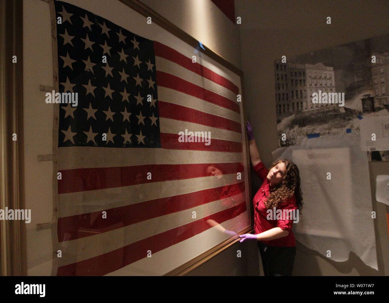 Catlin Carter a Conservation Lab Technician at the Missouri History Museum straightens a 34 star American flag from the Civil War era as the 'Civil War in Missouri,' display continues to set up at the Museum in St. Louis on November 8, 2011. To commemorate the sesquicentennial of the Civil War the Missouri History MuseumÕs comprehensive The Civil War in Missouri will feature items from America's bloodiest conflict. UPI/Bill Greenblatt Stock Photo
