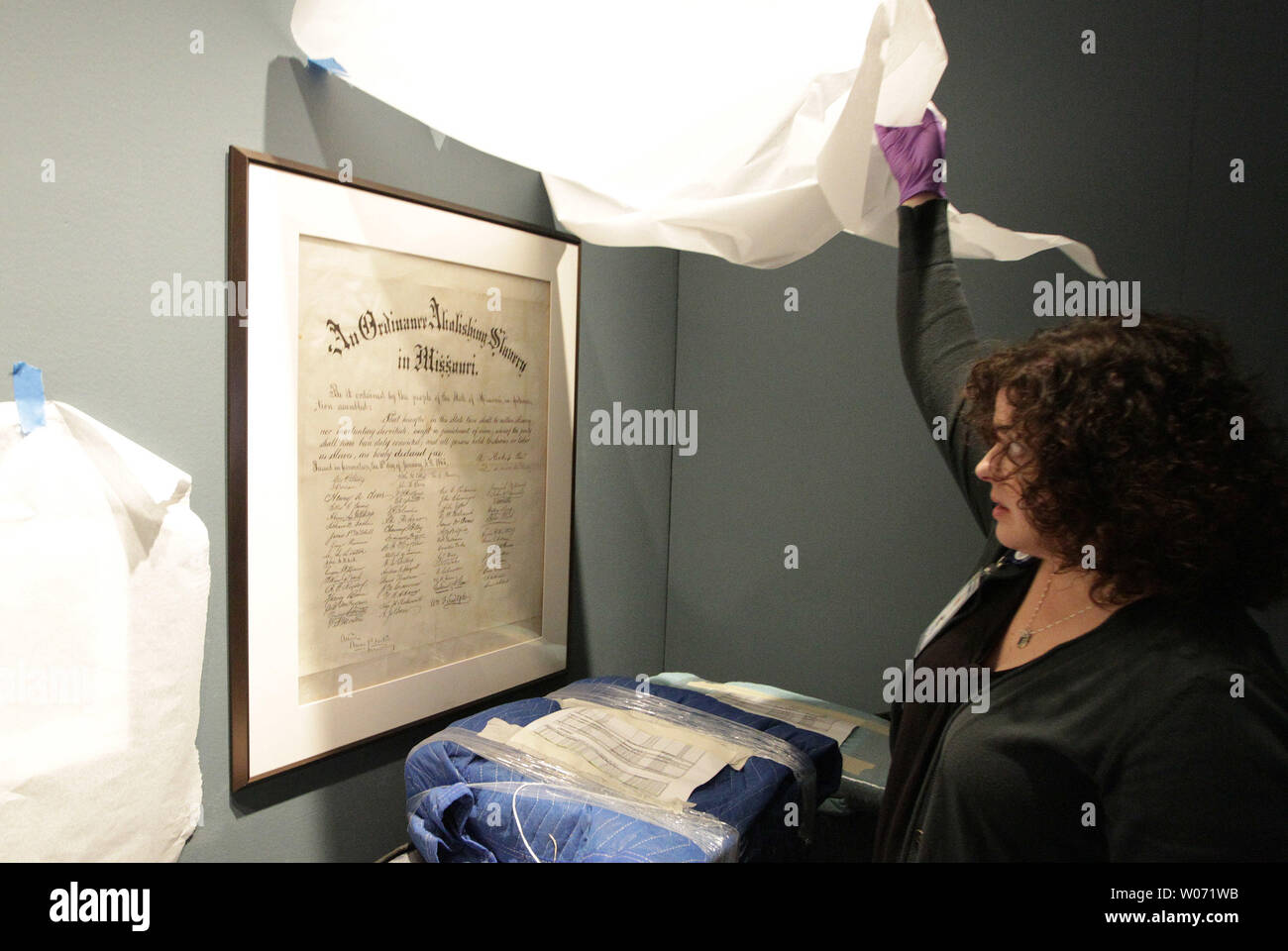 Amy Berra, Registrar at the Missouri History Museum uncovers a document that abolishes slavery in Missouri from the Civil War era as the 'Civil War in Missouri,' display continues to set up at the Museum in St. Louis on November 8, 2011. To commemorate the sesquicentennial of the Civil War the Missouri History MuseumÕs comprehensive The Civil War in Missouri will feature items from America's bloodiest conflict. UPI/Bill Greenblatt Stock Photo