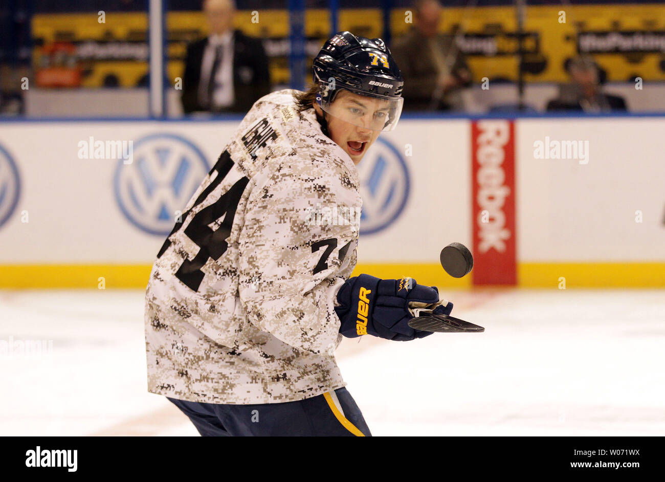 St. Louis Blues T.J. Oshie stretches during warmups, while wearing a  camouflage sweater before a game against the Toronto Maple Leafs in the  first period at the Scottrade Center in St. Louis on November 10, 2011. The  Blues wore the tops in honor of