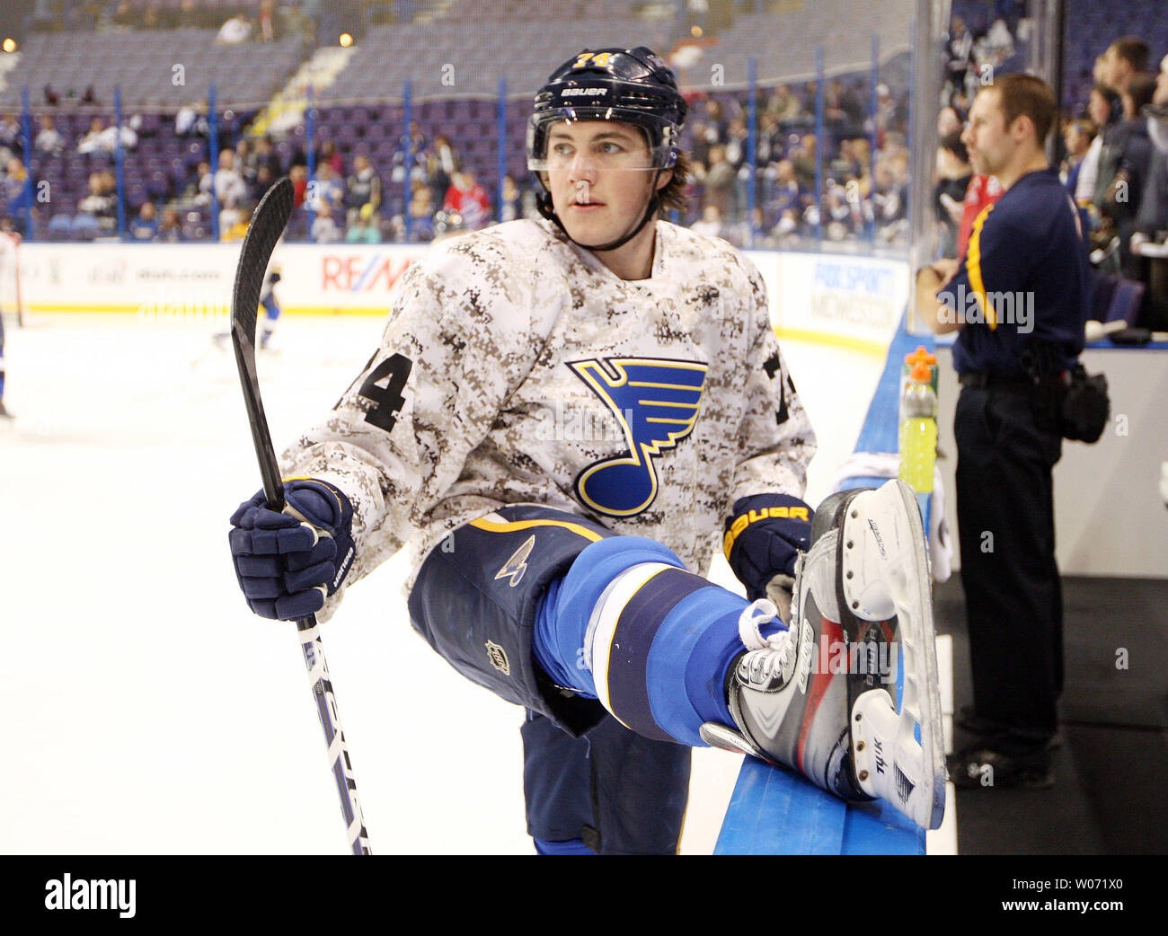 St. Louis Blues T.J. Oshie stretches during warmups, while wearing a  camouflage sweater before a game against the Toronto Maple Leafs in the  first period at the Scottrade Center in St. Louis