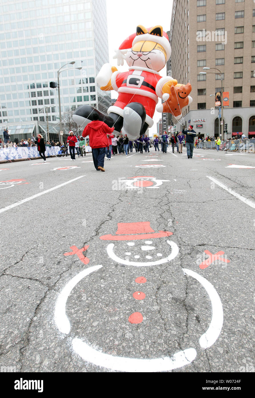 Garfield the balloon makes its way up Broadway ahile the streets are painted with Santa's during the Christmas in St. Louis Parade in St. Louis on November 24, 2011. UPI/Bill Greenblatt Stock Photo