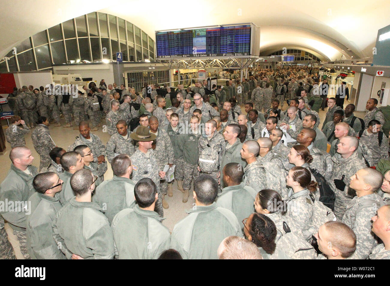 Troops from Fort Leonard Wood gather at Lambert-St. Louis International Airport as Holiday Block Leave begins in St. Louis on December 21, 2011. Approximately 4,000 troops are participating in Holiday Block Leave, the day when military installations release their personnel for the holidays. The USO of Missouri will host many of them as they find their way home.   UPI/Bill Greenblatt Stock Photo