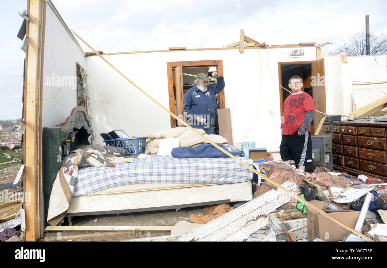 Keith Hucke (left) and Devyn Byrd, 14, survey the damage sustained to their house after a severe storm hit in the early morning hours on February 29, 2012, in Harrisrburg, IIlinois. Hucke said he was in his bed when the wall right next to him collapsed during the storm. UPI/Paul Newton/ The Southern Stock Photo