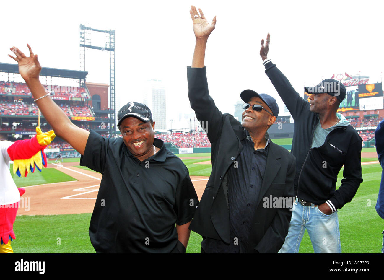 Members of the 1980's group Kool and the Gang wave to fans after being introduced before the Milwauke Brewers-St. Louis Cardinals baseball game at Busch Stadium in St. Louis on April 29, 2012. They are (L to R) Robert 'Kool' Bell, Ronald Bell and George Brown. UPI/Bill Greenblatt Stock Photo