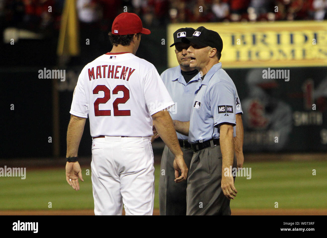 St. Louis Cardinals manager Mike Matheny talks with umpires Dan Iassogna (R) and Dale Scott after they called Carlos Beltran's hit a double in the third inning against the Pittsburgh Pirates at Busch Stadium in St. Louis on May 2, 2012. The play was reviewed and changed to a three run home run.   UPI/Bill Greenblatt Stock Photo