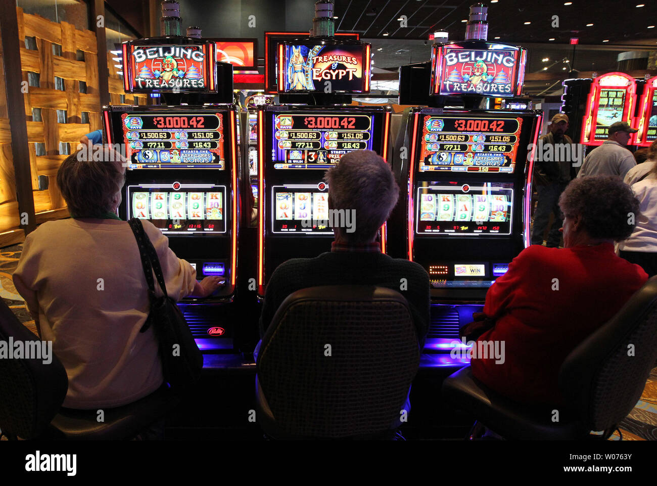 Gamblers sit at the slot machines in the opening minutes of the new Isle of Capri Casino in Cape Girardeau, Missouri on October 30, 2012. The $135 million casino next to the Mississippi River, received over 9,000 applications for employment but selected 725 of the best to be on staff.  UPI/Bill Greenblatt Stock Photo