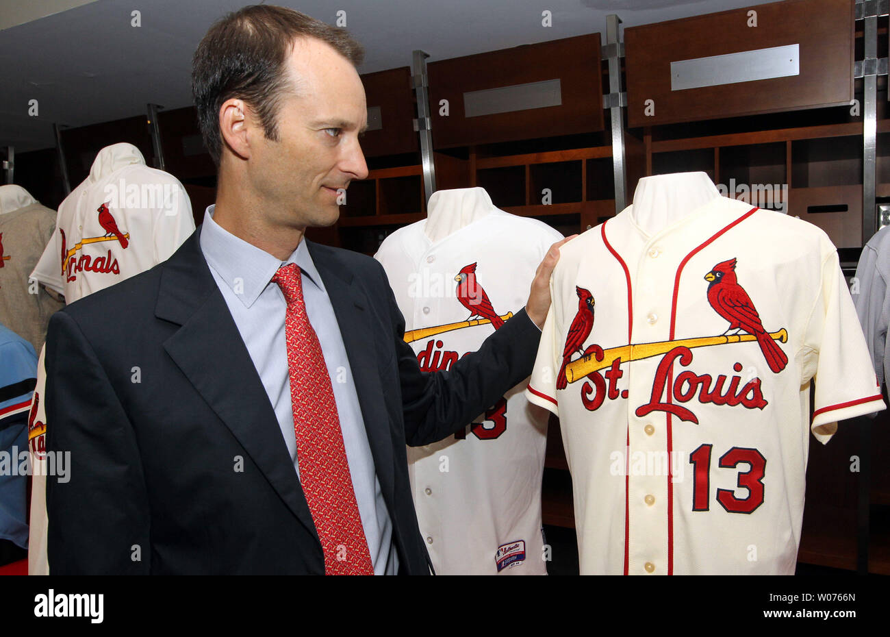 St. Louis Cardinals Bill DeWitt III gets a closer look at the new team  uniform jersey at Busch Stadium in St. Louis on November 16, 2012. For the  first time in 80