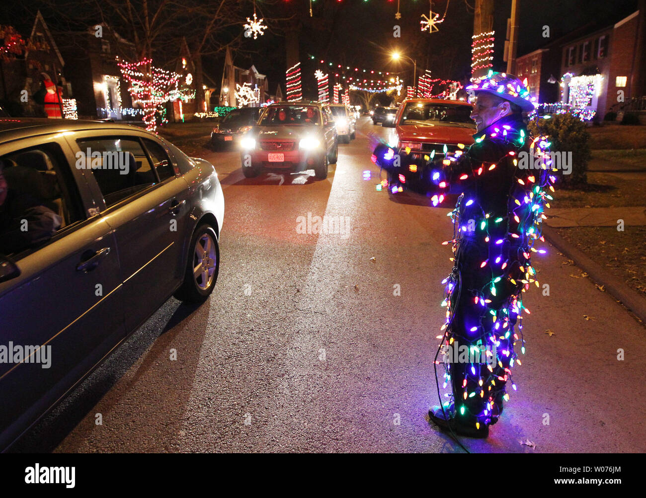 Nick Zervos greets drivers in his Light Man suit, as they slow to look ...