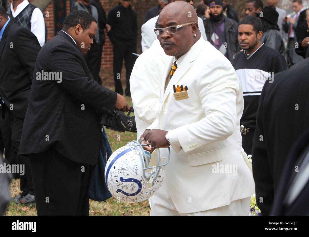 Vincent Thomas Sr. of the Reliable Funeral Directors, removes an autographed Indianapolis Colts helmet from atop the casket of Jerry Brown, Jr. during his funeral at the Hopewell Missionary Baptist Church in St. Louis on December 15, 2012. The Dallas CowboysÕ practice squad nose tackle was killed in an Irving car accident on December 8, 2012 when his best friend and teammate Josh Brent hit a curb, flipping the vehicle. Brown appeared in just one game for the Indianapolis Colts this season and did not stat.  UPI/Bill Greenblatt Stock Photo