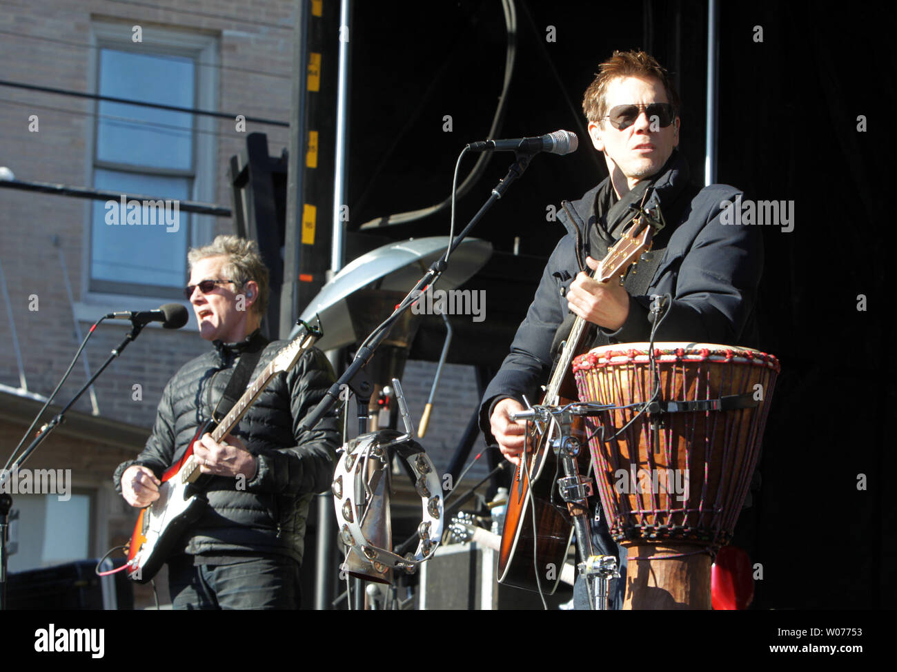 Actor Kevin Bacon (R) and his brother Michael perform for fans as the