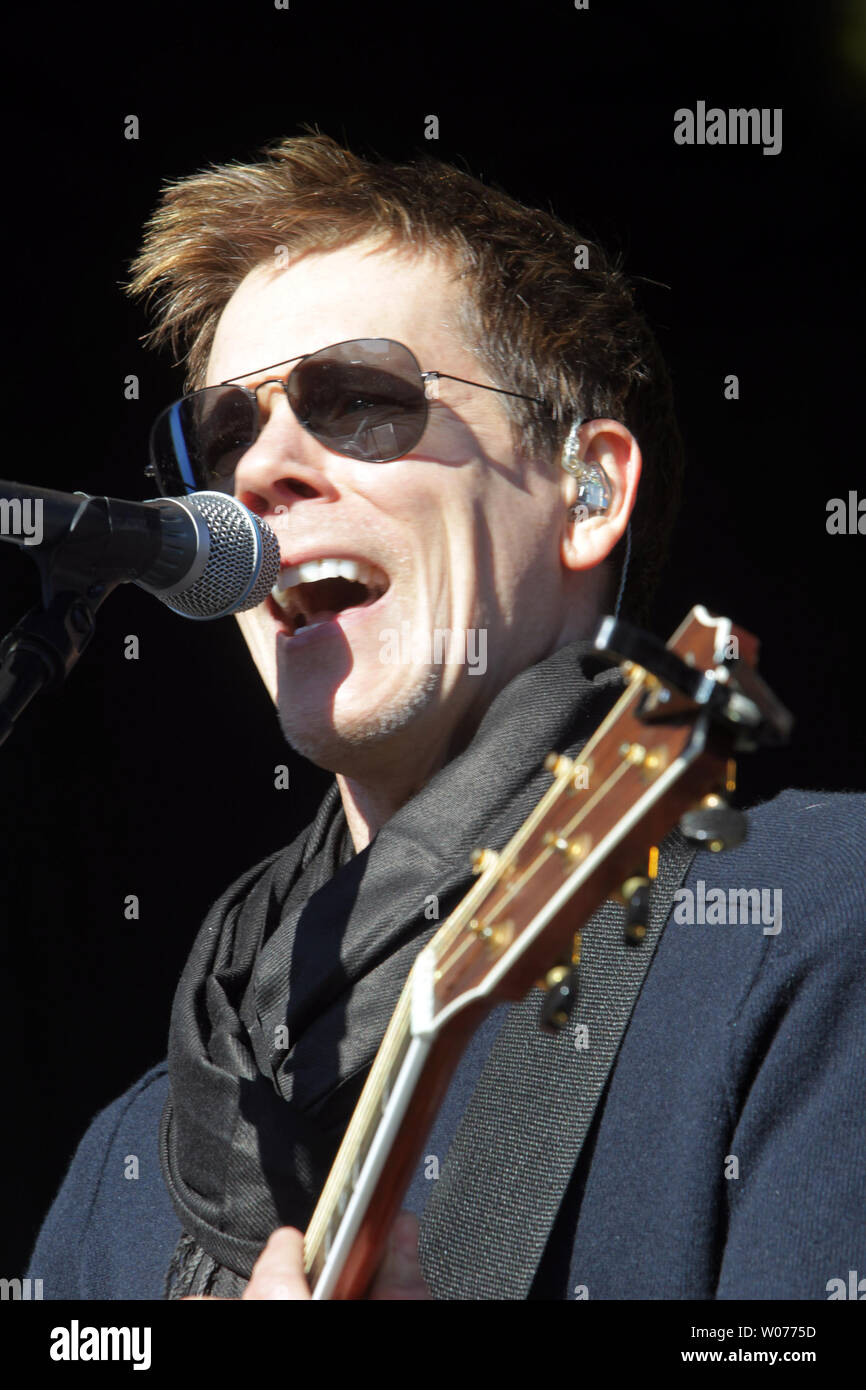 Actor Kevin Bacon performs on stage with his brother Michael as the