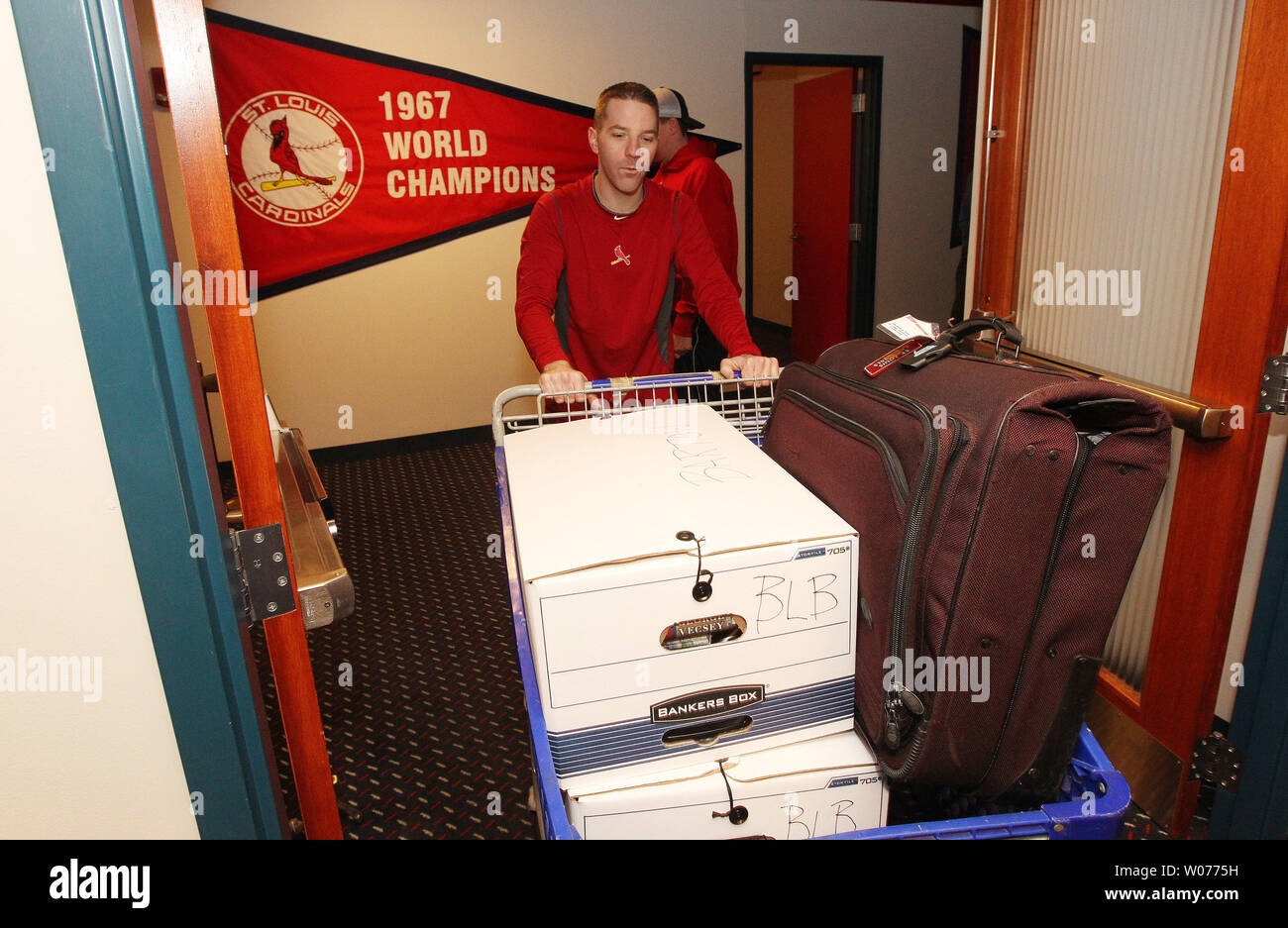 St. Louis Cardinals clubhouse attendant Nate Pfister displays the