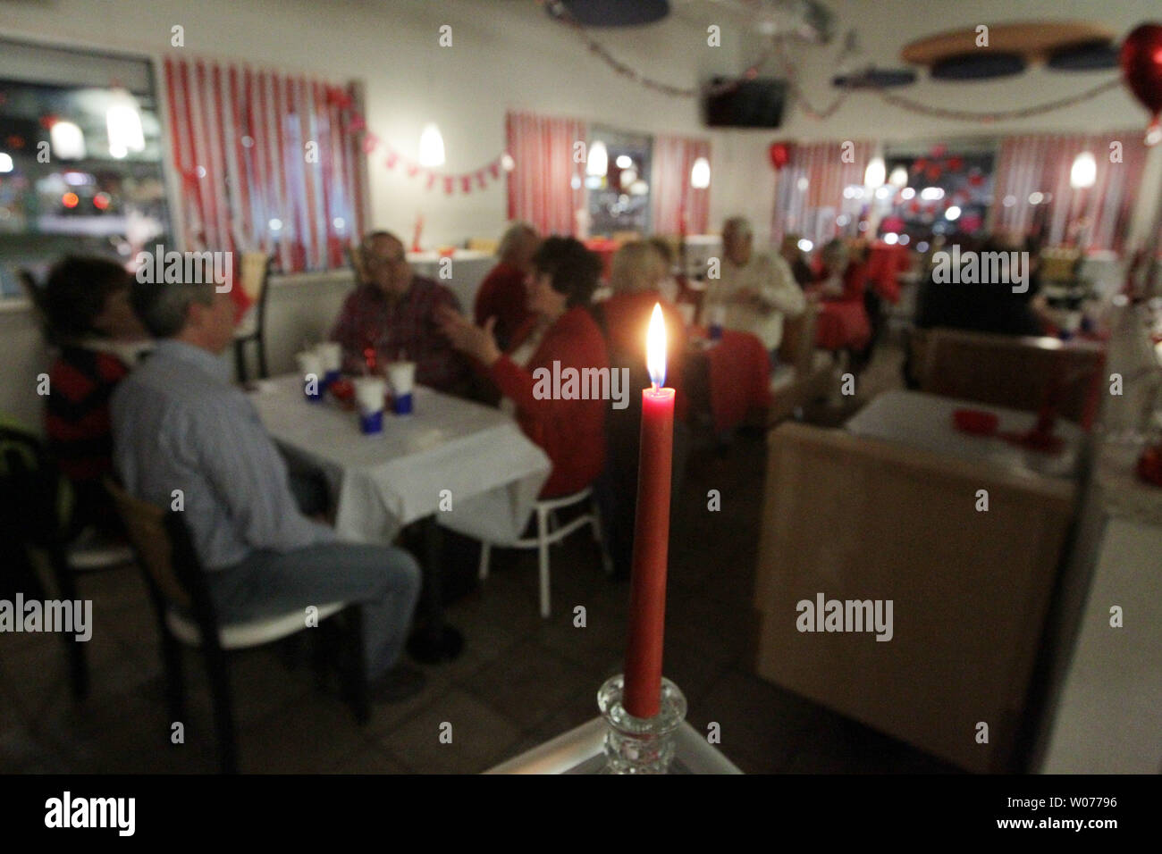 Candles illuminate the dining room at the White Castle restaurant in Kirkwood, Missouri on February 14, 2013. The burger joint, home of the 69 cent slider, converts itself on into a romantic eating establishment with tablecloths, candles and table service for dinner on Valentines Day. UPI/Bill Greenblatt Stock Photo