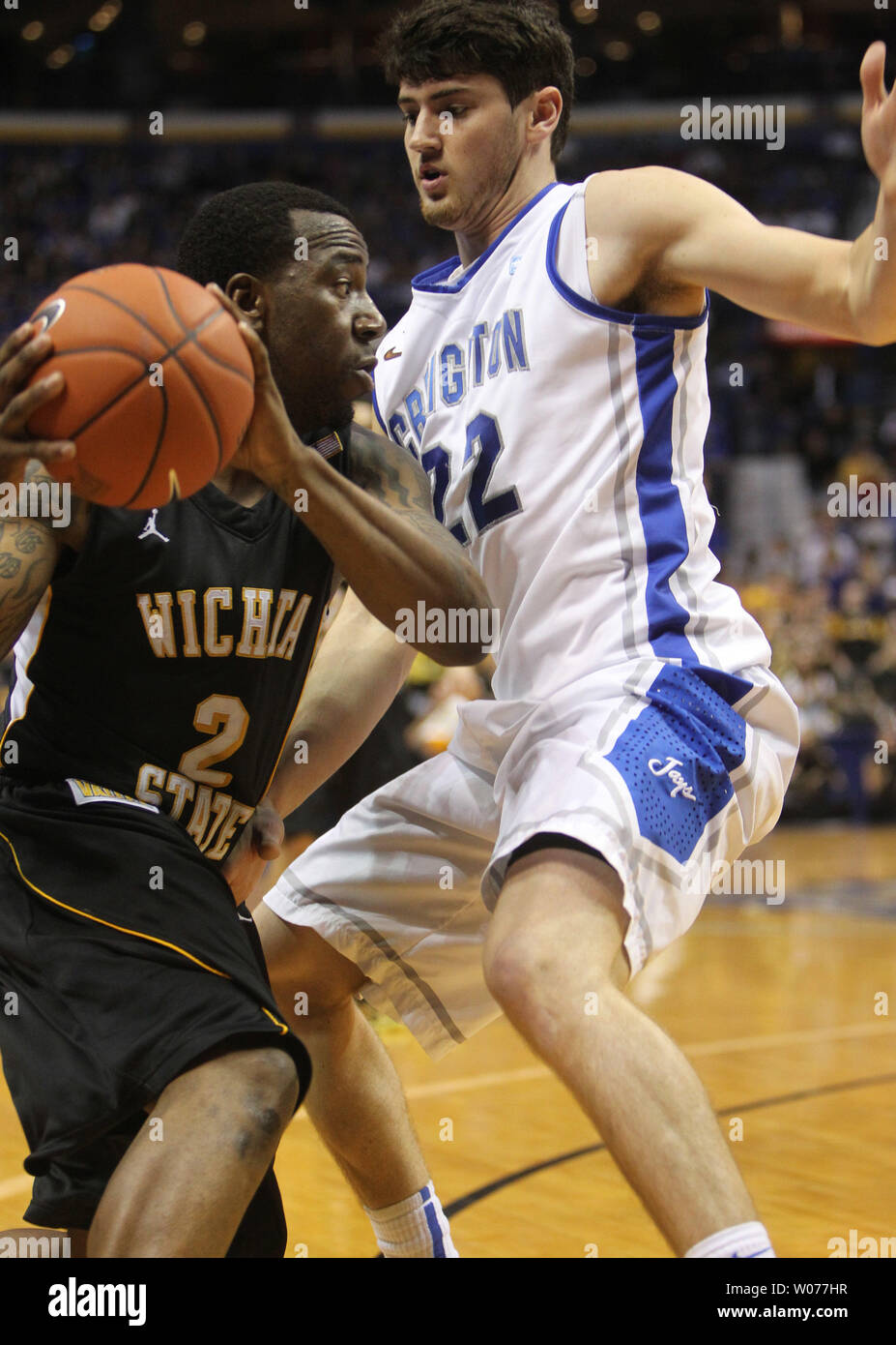 Creighton's Avery Dingman (22) blocks the progress of Wichita State's Malcolm Armstead in the first half of the Missouri Valley Tournament championship game at the Scottrade Center in St. Louis on March 10, 2013.    UPI/Bill Greenblatt Stock Photo