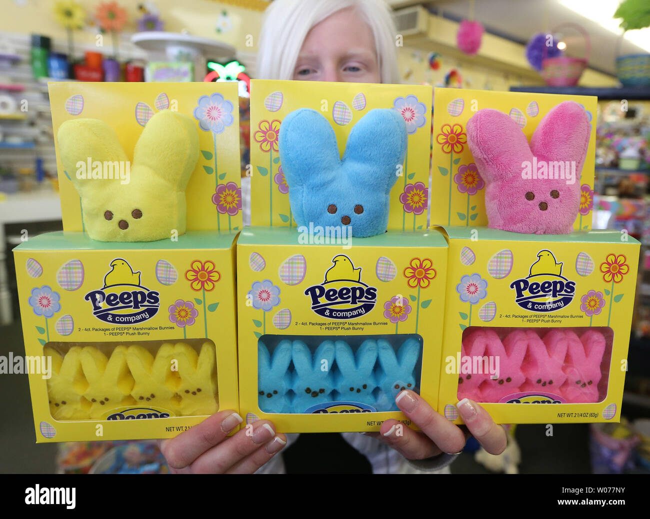 Saleswoman Mandy Puchel displays a new version of the popular candy Peeps that includes a stuffed animal at Sweet Be's Candy and Gifts in Des Peres, Missouri on March 27, 2013. Sales for stuffed animals, candy and toys have been brisk as Easter approaches on March 31.     UPI/Bill Greenblatt Stock Photo