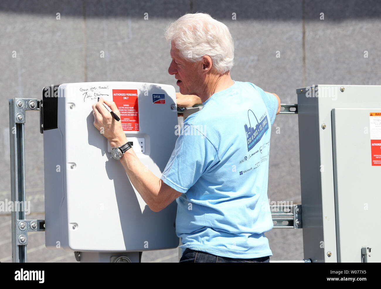 Former U.S. President Bill Clinton signs a solar panel inverter box during a Day of Service at the Gateway STEM High School in St. Louis on April 7, 2013. Clinton is in St. Louis for day 3 of the Clinton Global Initative.  UPI/Bill Greenblatt Stock Photo