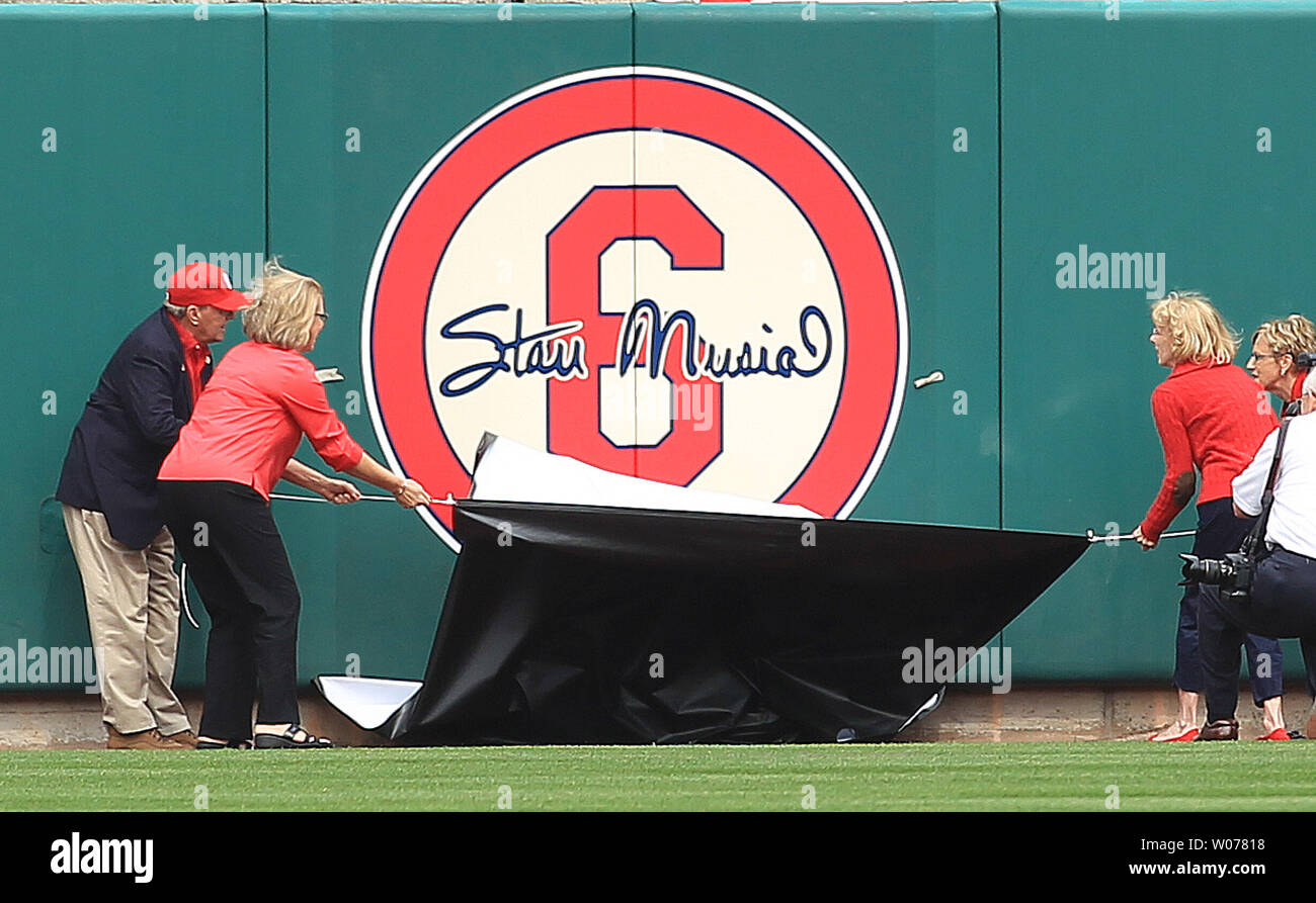 The children of the late Stan Musial pull the cover off of the number 6 on the laft center field wall  before the St. Louis Cardinals-Cincinnati Reds baseball game at Busch Stadium in St. Louis on April 8, 2013.  The Hall of Fame member died in January.    UPI/Bill Greenblatt Stock Photo
