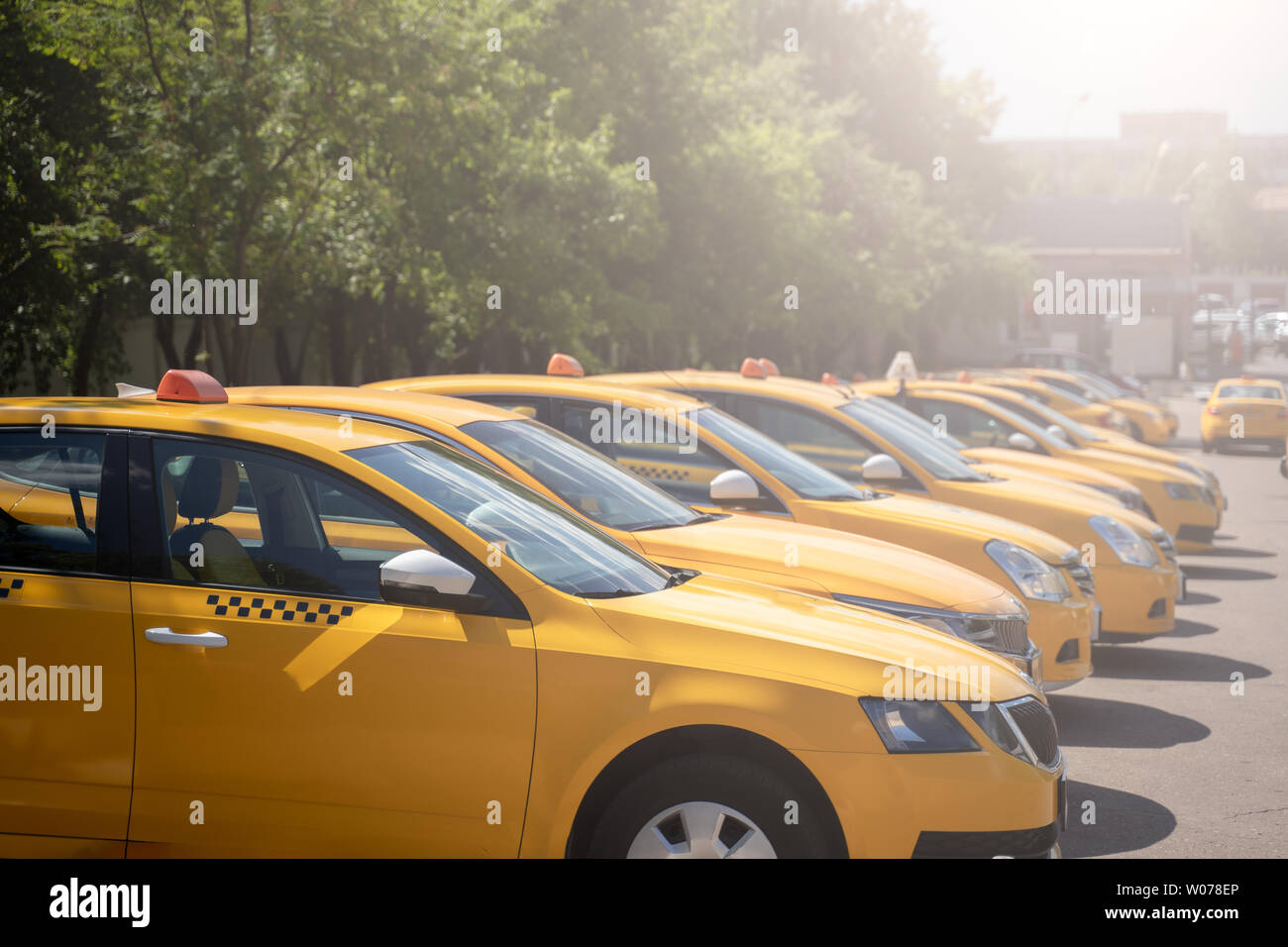 Photo of several yellow taxi on street in summer afternoon Stock Photo