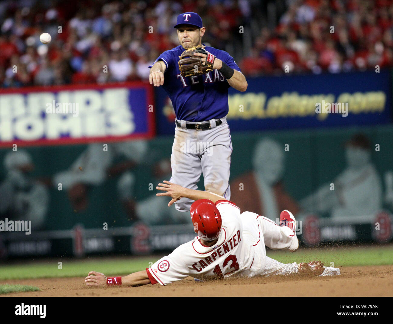 Texas Ranger Ian Kinsler jumps over St.Louis Cardinial Matt Carpenter in  the 8th inning at Busch Stadium in St. Louis on June 22, 2013. The Rangers  defeated the Cardinals 4-2 UPI/Rob Cornforth