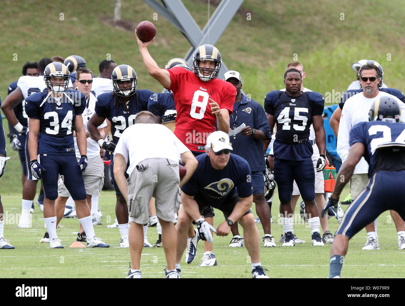 St. Louis Rams quarterback Sam Bradford throws the football as head coach Jeff Fisher (R) looks on during training camp at the team practice facility in Earth City , Missouri on July 29, 2013.   UPI/Bill Greenblatt Stock Photo