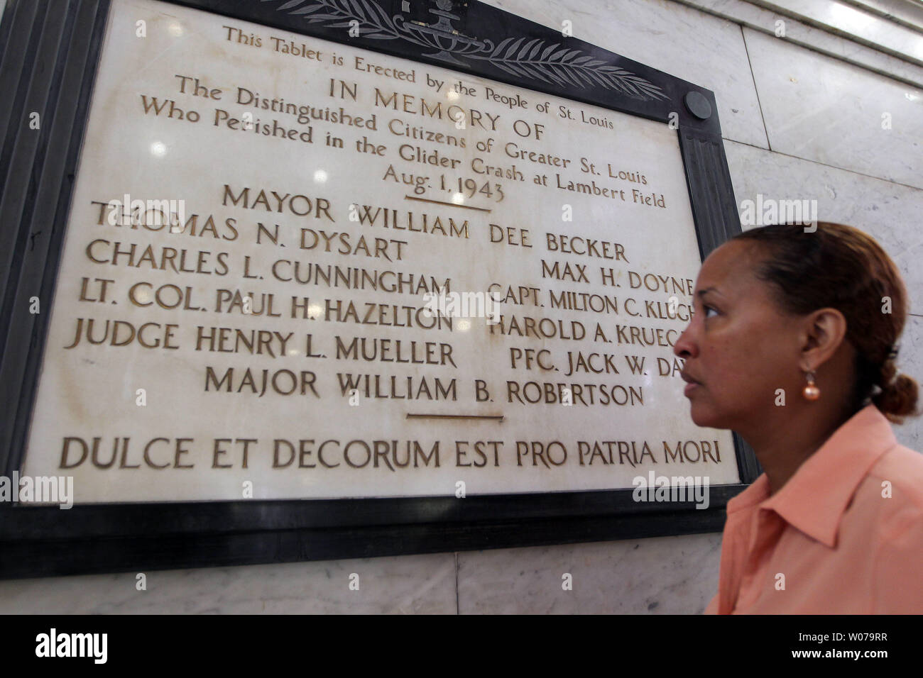 Sable Campbell-Jones, Director of Diversity for the City of St. Louis, stops to read a placque remembering a glider crash that killed the Mayor of St. Louis and nine others, on the 70th anniversary in City Hall in St. Louis on August 1, 2013.  The glider, which had passed Army testing, had made a flight earlier in the day, but crashed nose first at Lambert Field after the wing fell off on its second flight, carrying dignitaries.     UPI/Bill Greenblatt Stock Photo