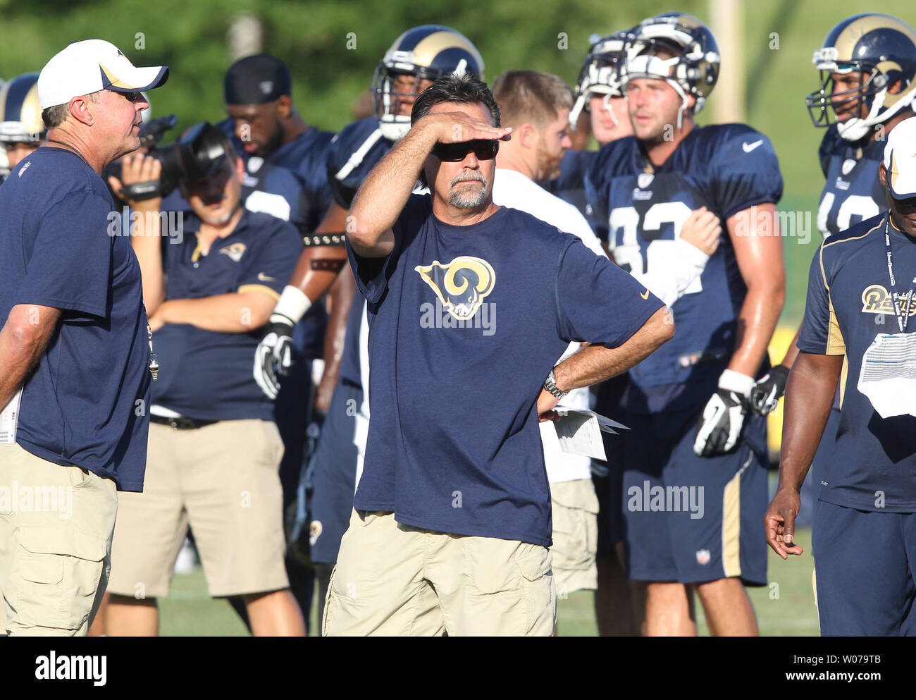 St. Louis Rams head football coach  Jeff Fisher shields his eyes from the afternoon sun during training camp at the team practice facility in Earth City , Missouri on August 1, 2013.   UPI/Bill Greenblatt Stock Photo