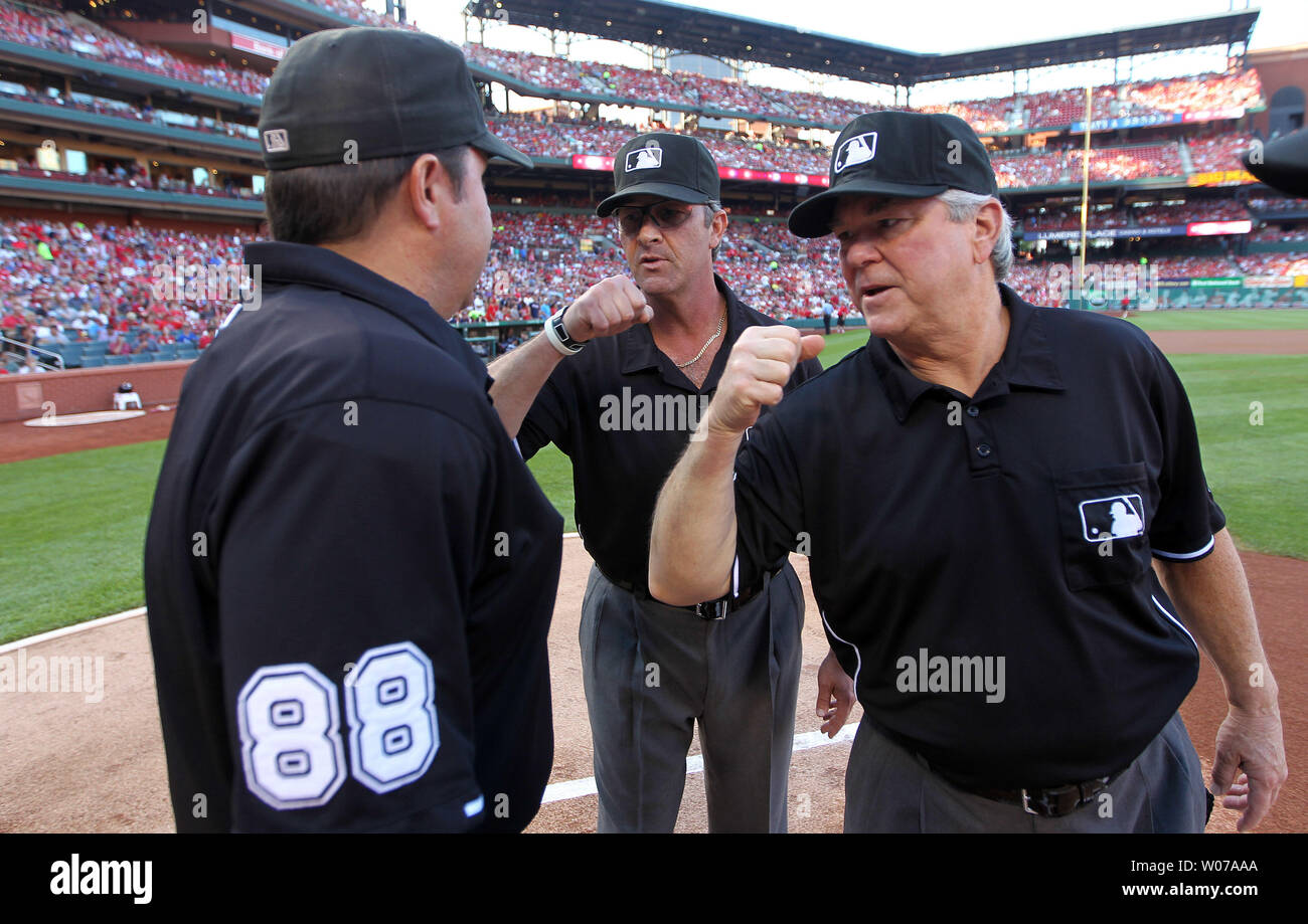 Umpires Paul Nauert (C) and Dana DeMuth (R) give home plate umpire Doug