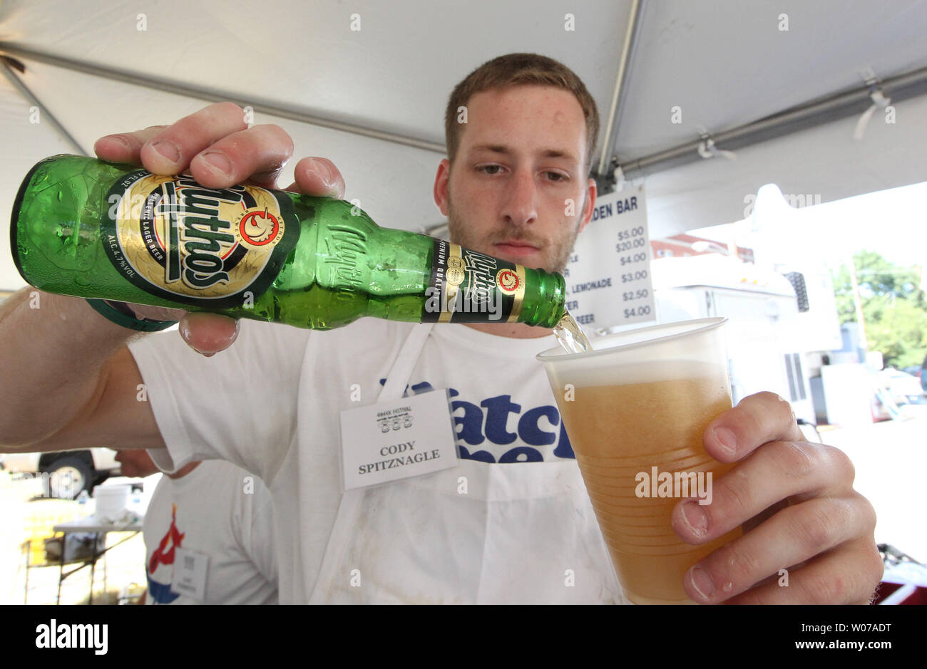 Cody Spitznagle pours a Mythos greek beer in the beer garden at the Greek Festival in St. Louis on September 2, 103. The annual festival drew record numbers for a single day due to the cooler weather. UPI/Bill Greenblatt Stock Photo