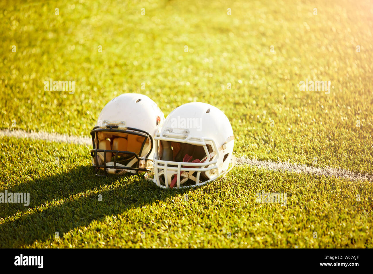 Photo of two football helmets on stadium Stock Photo Alamy