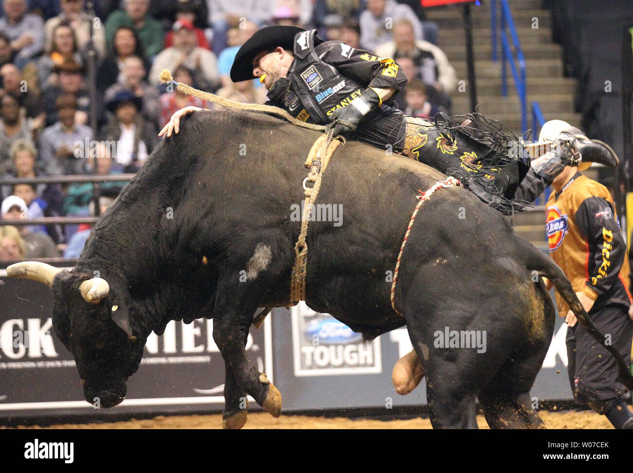 Douglass Duncan holds onto My Kinda Party the bull during the second round of the Professional Bull Riders at the Scottrade Center in St. Louis on February 15, 2014. UPI/Bill Greenblatt Stock Photo