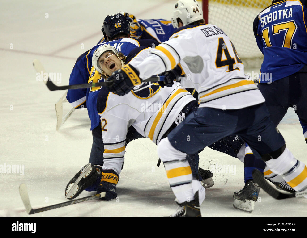 Buffalo Sabres Marcus Foligno yells out in pain after getting his leg bent back in a collission with St. Louis Blues Roman Polak of the Czech Republic in the first period at the Scottrade Center in St. Louis on April 3, 2014. UPI/Bill Greenblatt Stock Photo
