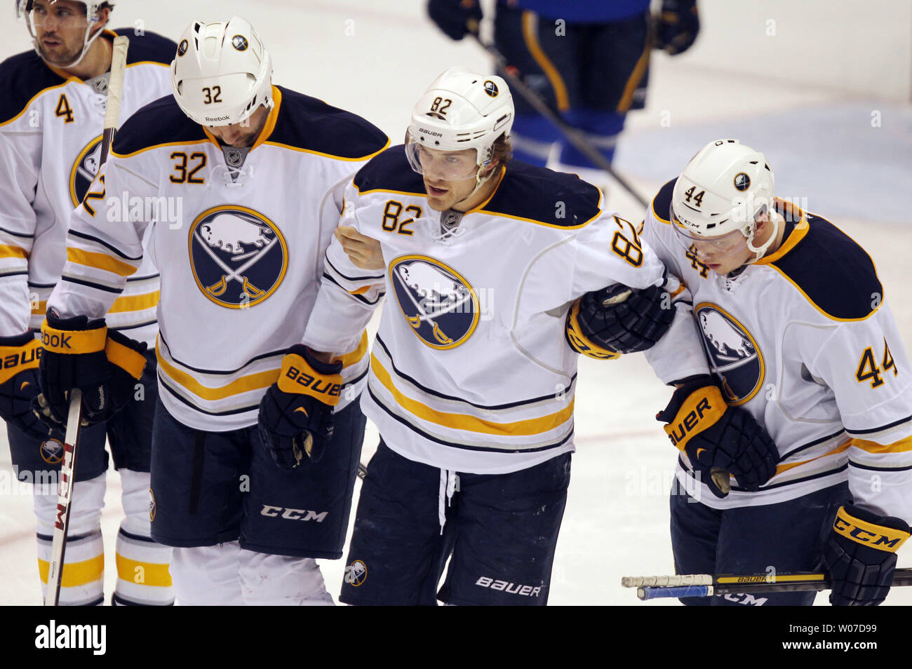 Buffalo Sabres Marcus Foligno (82) is helped off the ice by teammates John Scott (32) and Nicolas Deslauriers after a collission with St. Louis Blues Roman Polak of the Czech Republic in the first period at the Scottrade Center in St. Louis on April 3, 2014. UPI/Bill Greenblatt Stock Photo