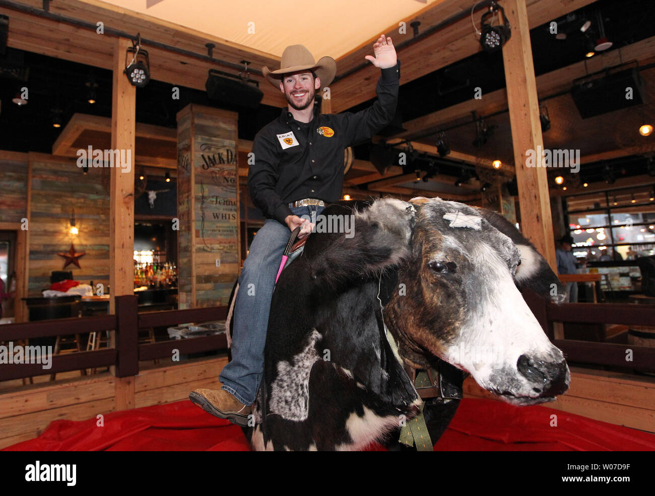 Professional bullrider Luke Snyder of Springfield, Missouri tries his hand at riding Ozzie, the mechanical bull during grand opening festivities at the PBR Bar in Ballpark Village in St. Louis on April 4, 2014. The PBR Bar is the seventh one to open in the country.  UPI/Bill Greenblatt Stock Photo