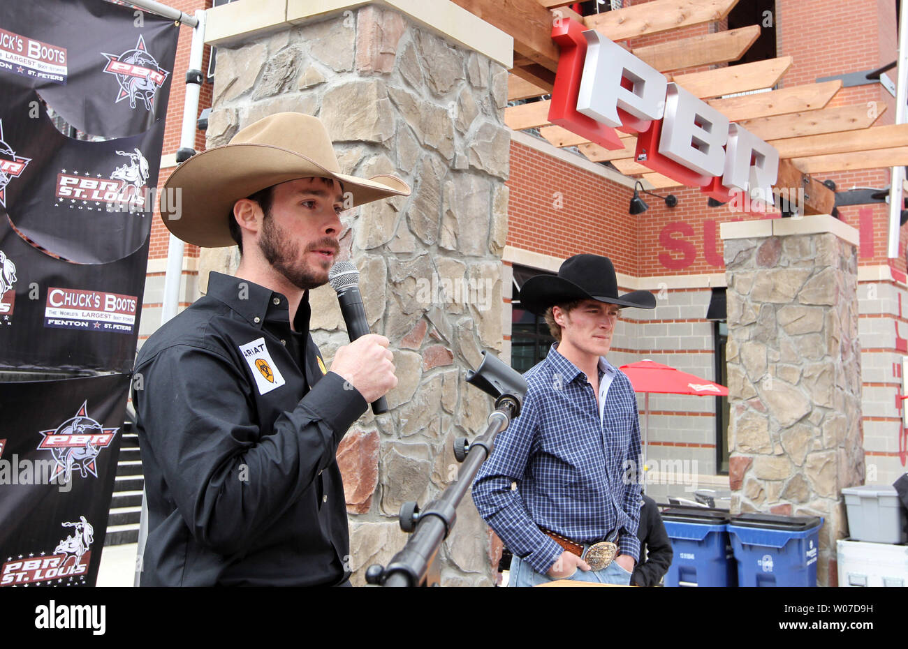 Professional bullrider Luke Snyder talks to the crowd while fellow rider Reese Cates listens in during grand opening festivities at the PBR Bar in Ballpark Village in St. Louis on April 4, 2014. The PBR Bar is the seventh one to open in the country.  UPI/Bill Greenblatt Stock Photo