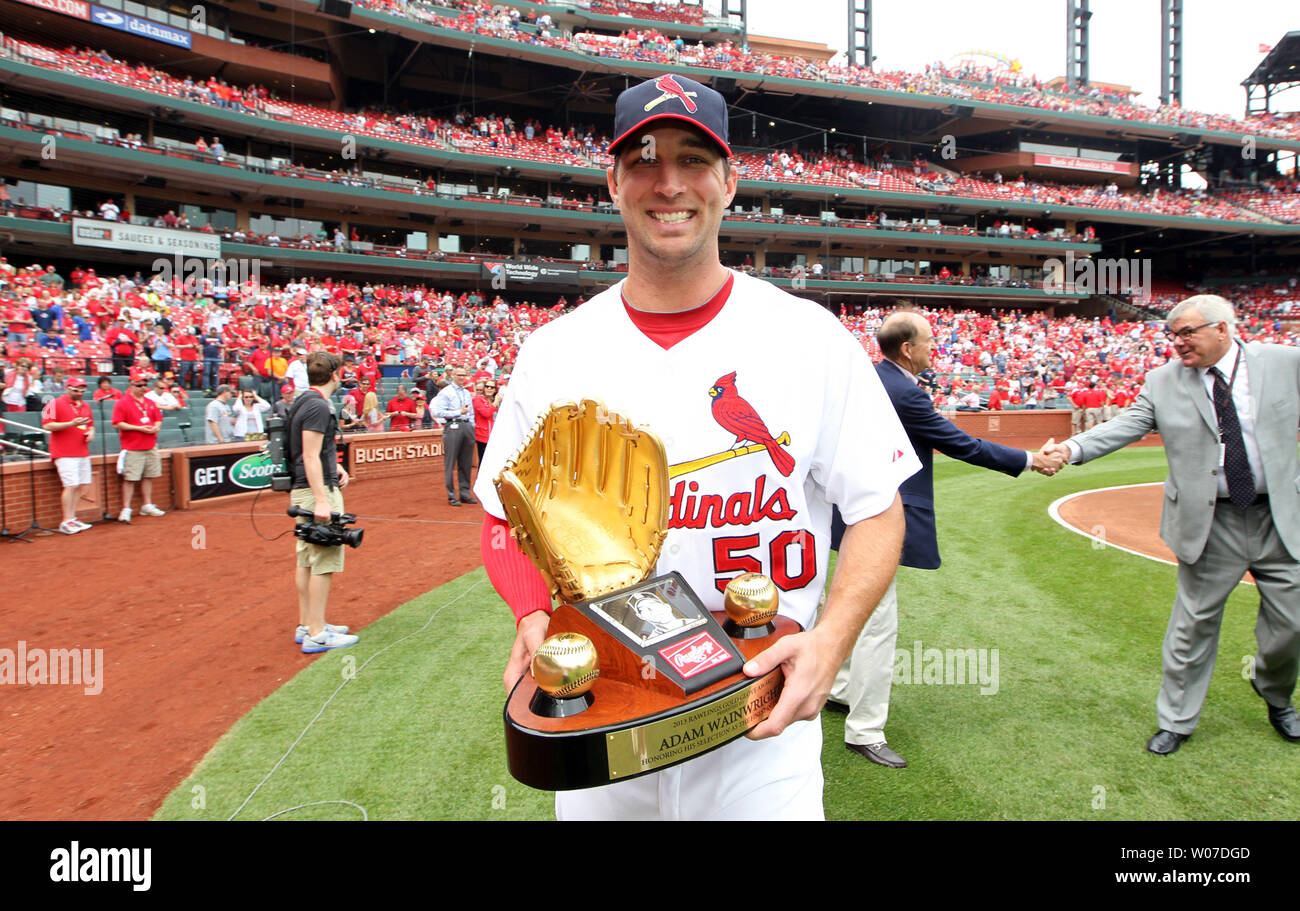 St. Louis Cardinals starting pitcher Adam Wainwright walks off the field carrying his gold glove award given to him by the Rawlings Company before a game against the Chicago Cubs at Busch Stadium in St. Louis on April 13, 2014.   UPI/Bill Greenblatt Stock Photo