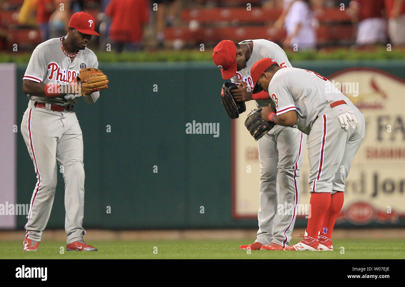 Philadelphia Phillies outfielders (L to R) Domonic Brown, John Mayberry Jr. and Marlon Byrd bow to each other after the third out and a 4-1 win over the St. Louis Cardinals at Busch Stadium in St. Louis on June 18, 2014.  UPI/Bill Greenblatt Stock Photo